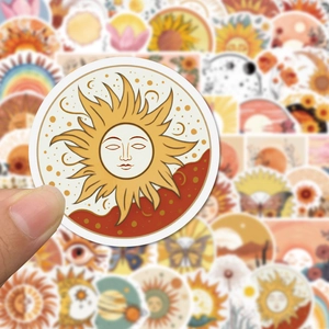 Handheld vintage boho sun sticker for laptops and guitars featuring celestial designs