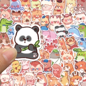 Hand holding a cute panda sticker from a set of 60 waterproof kawaii animal decals