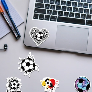 Waterproof soccer stickers with 3D and galaxy designs on a laptop and desk
