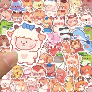 Close-up of cute cartoon lamb sticker with white border on a colorful sticker pile