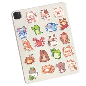 Close-up of cute macaron cartoon animal stickers on a white tablet back cover