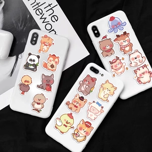 Detailed view of colorful waterproof cartoon animal stickers on white smartphone cases