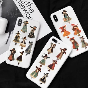 Close-up of cute cartoon witch stickers on phone cases with autumn aesthetic colors