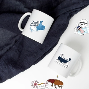 Close-up of biology and chemistry lab stickers applied to white ceramic mugs for students