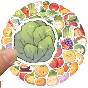 Close-up of a cute cartoon cabbage sticker held by fingers showing the size and detail