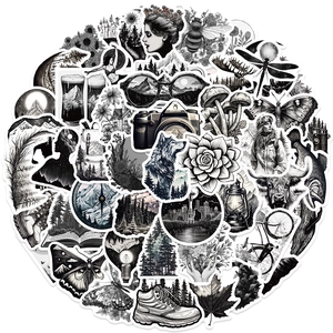 Close-up of black and white nature stickers featuring forests and retro travel gear
