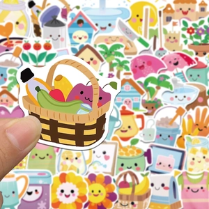 Close-up of a hand holding a cute fruit basket sticker with various cartoon patterns