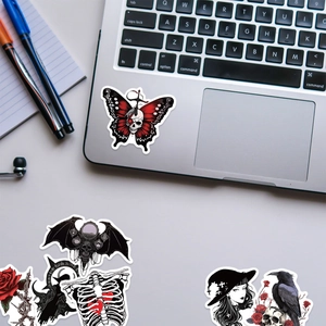 Gothic horror stickers with skulls and demons displayed on a laptop for Halloween decor