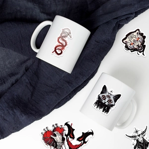 Gothic art stickers on white ceramic mugs with dragon and dark aesthetic motifs