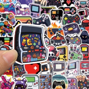 Close-up of retro gaming controller stickers being applied to a laptop surface