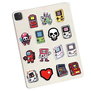 Retro gaming stickers set on a white tablet featuring arcade icons and pixel art decals