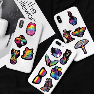 Psychedelic gradient graffiti stickers displayed on three white smartphone cases