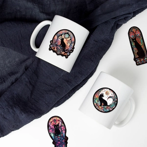 Detail of stained glass style gothic cat stickers applied on a white ceramic mug