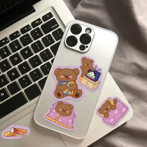 Detailed view of cute cartoon bear stickers applied to a white smartphone case