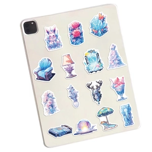Detailed view of 14 aesthetic ice-world stickers applied on a tablet for DIY decoration