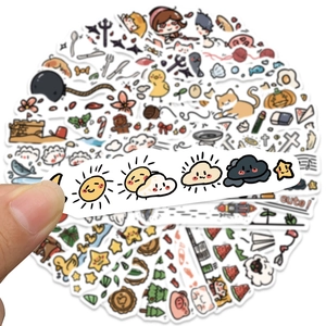 Close-up of cute cartoon doodle stickers with animals and weather patterns for journals