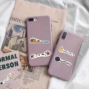 Close-up of light purple matte iPhone cases featuring cute cartoon beach stickers