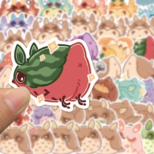 Close-up of a waterproof owl-watermelon hybrid cartoon sticker held by hand