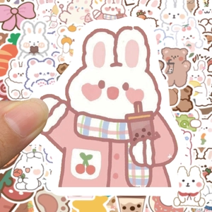 Close-up of cute cartoon bear and bunny stickers for DIY decoration on scrapbooks