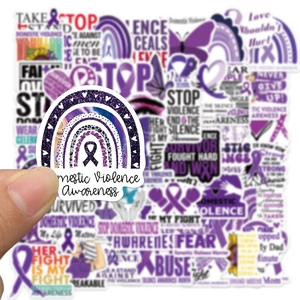 Close-up of a purple domestic violence awareness sticker with glitter vinyl texture