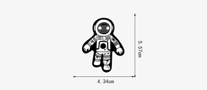 Detailed dimensions of a black and white cartoon astronaut sticker showing size 5.57 by 4.34 cm