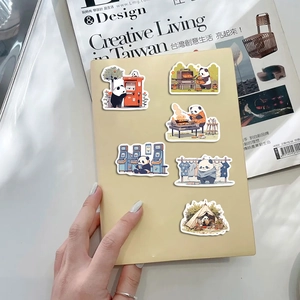 Close-up of cute panda stickers on notebook featuring daily activities and creative scenes