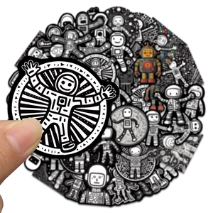 Detailed view of astronaut and robot stickers on hand for luggage and laptop decor