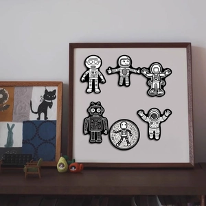 Detail view of 6 black and white astronaut stickers in a mini wooden frame display
