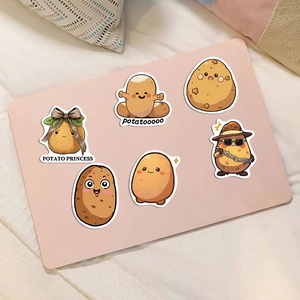 Detailed view of cute potato cartoon stickers applied on a pink laptop surface