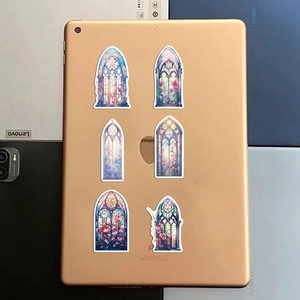 Detailed view of colorful gothic church window stickers on a gold tablet surface
