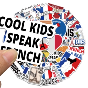 Close-up of waterproof French travel stickers with Eiffel Tower and French map patterns
