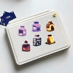 Detail of magical juice bottle stickers with bone juice theme on a laptop sleeve