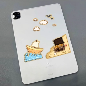 Cartoon nautical stickers with sailboat and treasure chest on an iPad Pro back