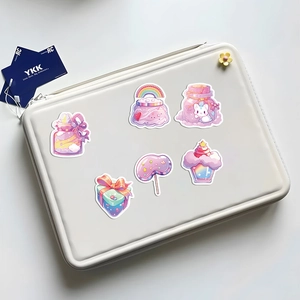 Set of 50 cartoon candy stickers featuring colorful desserts on a laptop surface