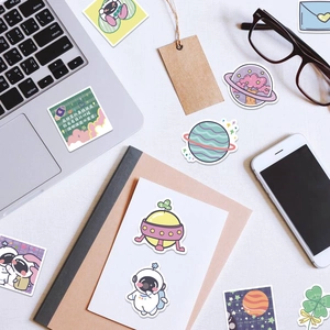 Cute astronaut stickers in pastel tones for laptop and phone decoration close-up view