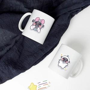 Close-up of cute cartoon astronaut stickers applied on white ceramic mugs for decoration