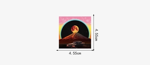 Detail showing 4.55cm square sticker with retro car and volcano eruption print