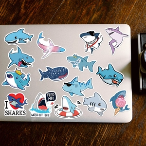 50pcs cute cartoon shark graffiti stickers on a laptop with wooden background scene