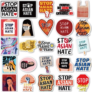 Flat lay of Stop Asian Hate waterproof stickers with diverse slogans and illustrations