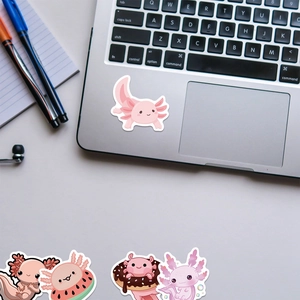 Cute pink axolotl stickers applied on a laptop surface for creative decoration