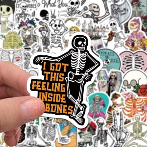 Close-up of waterproof PVC skull stickers with funny phrases for laptop and guitar