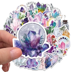 Close-up of hand holding a dream crystal PVC sticker showing waterproof material quality
