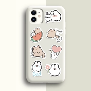 Cute cartoon cat and rabbit stickers decorated on a cream silicone phone case surface