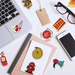 Flat lay of fire-themed cartoon stickers on laptop and notebook for decoration
