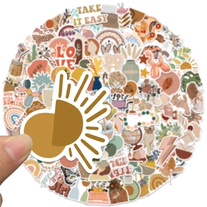Close-up of bohemian sticker being held showing sun motif and matte vinyl texture