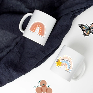 Minimalist ceramic mugs set with rainbow and little star stickers on white background