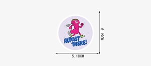 Close-up of a pink cartoon sticker with ALMOST THERE text showing 5cm dimensions