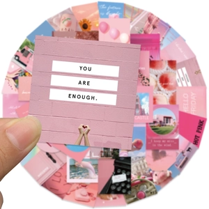 Detail showing various pink aesthetic stickers with inspirational quotes and scenery