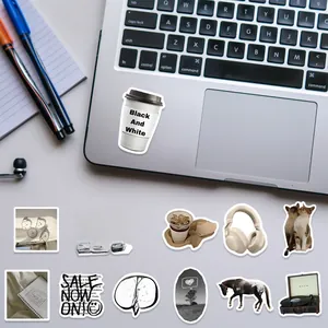 Detail of 60pcs monochrome coffee and bear stickers on a laptop surface for decoration