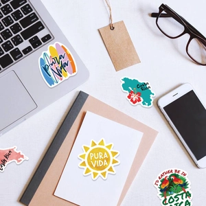 Flatlay of Costa Rica and Pura Vida vinyl stickers on laptop and travel stationery
